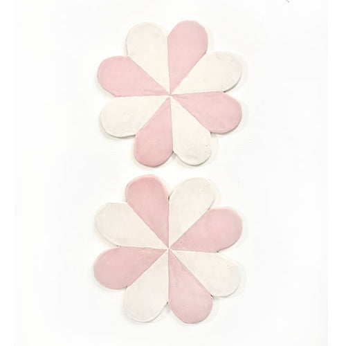 Pretty pink pinwheel pottery plates for hanging on the wall.