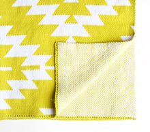 Load image into Gallery viewer, Yellow cotton knit crib blanket for a modern nursery.