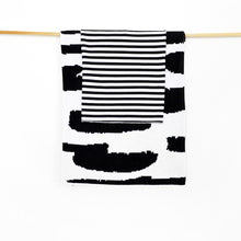 Load image into Gallery viewer, Hanging black-and-white baby blankets One blanket is stripe and the other is black and white abstract.