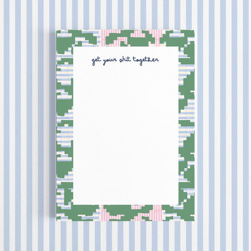 Notepad with a decorative border and text on a white background