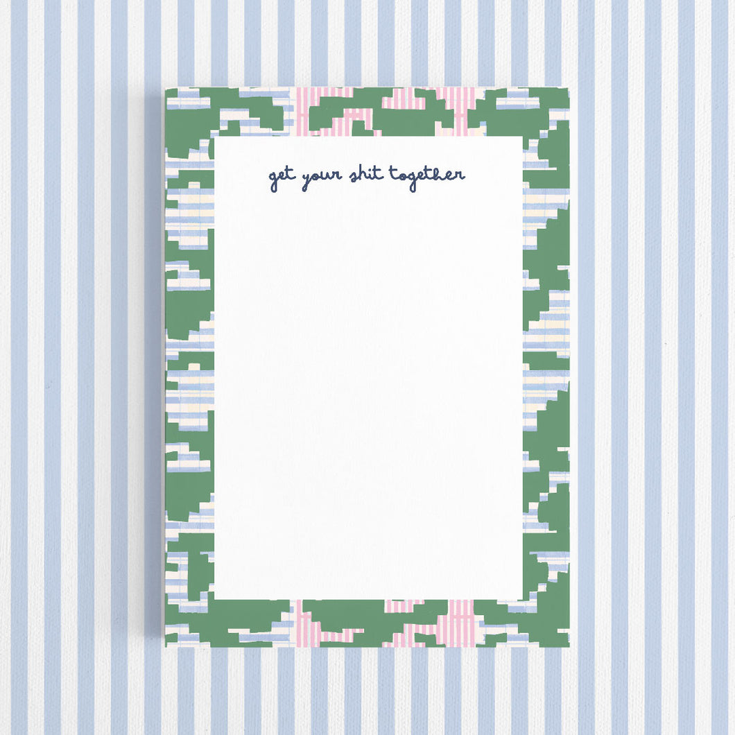Notepad with a decorative border and text on a white background
