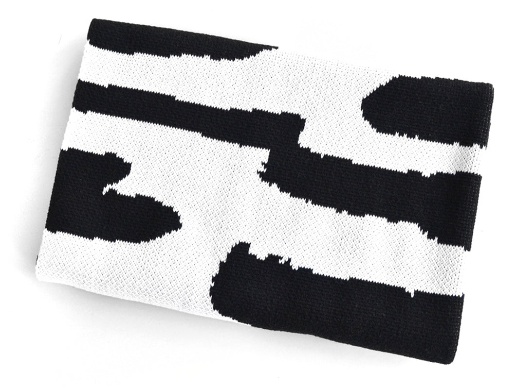 Reversible black and white knit baby blanket folded, modern abstract design by Wren & Rumor