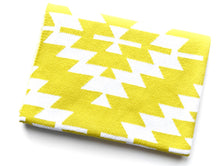 Load image into Gallery viewer, Yellow cotton knit crib blanket for a modern nursery.

