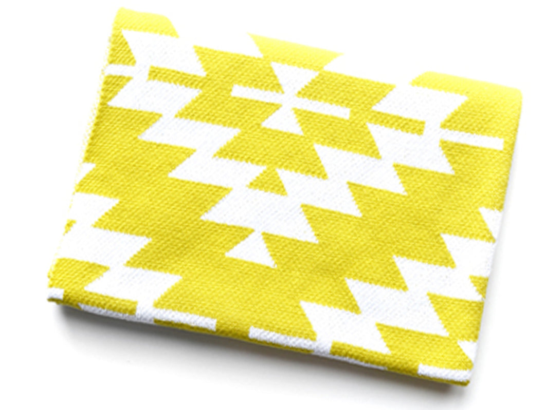 Yellow cotton knit crib blanket for a modern nursery.